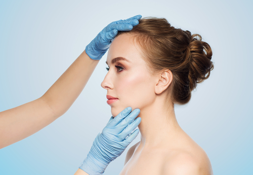 surgeon or beautician hands touching woman face over-img-blog