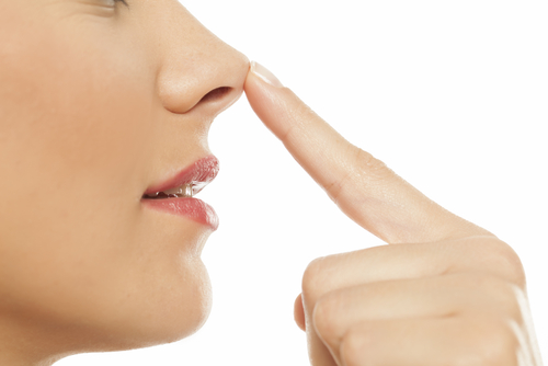 young woman touching her nose with her finger-img-blog