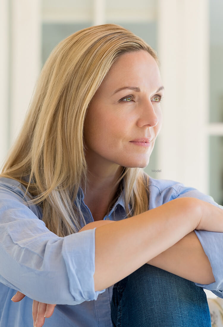 Woman resting arms on knees