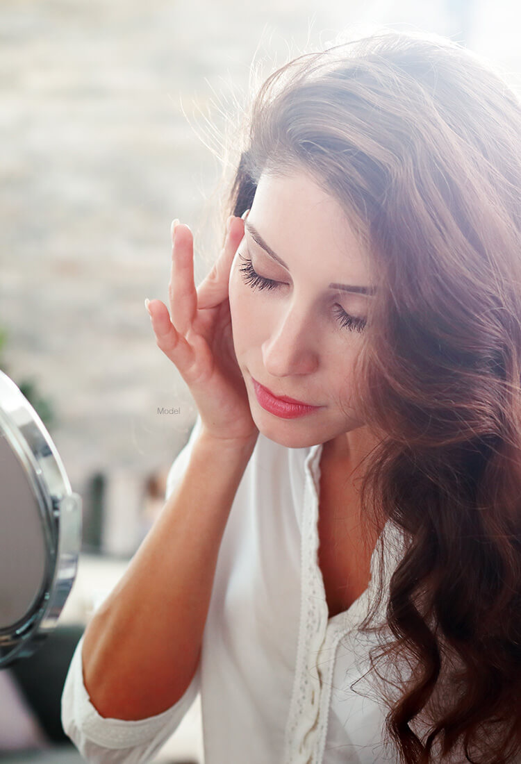 Beautiful woman looking in mirror