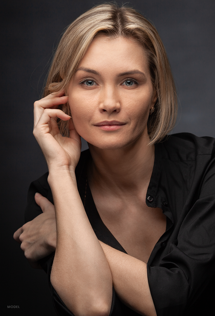 Headshot of a blonde woman with a focused look on her sculpted face