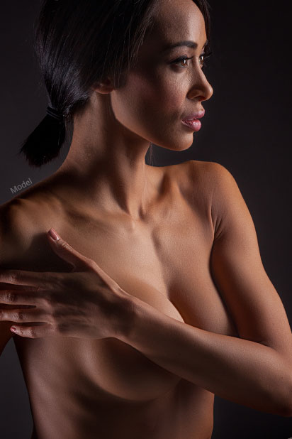 Woman with arm covering her breast